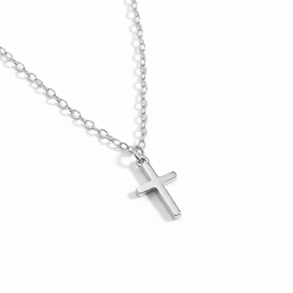Silver cross necklace on a white background