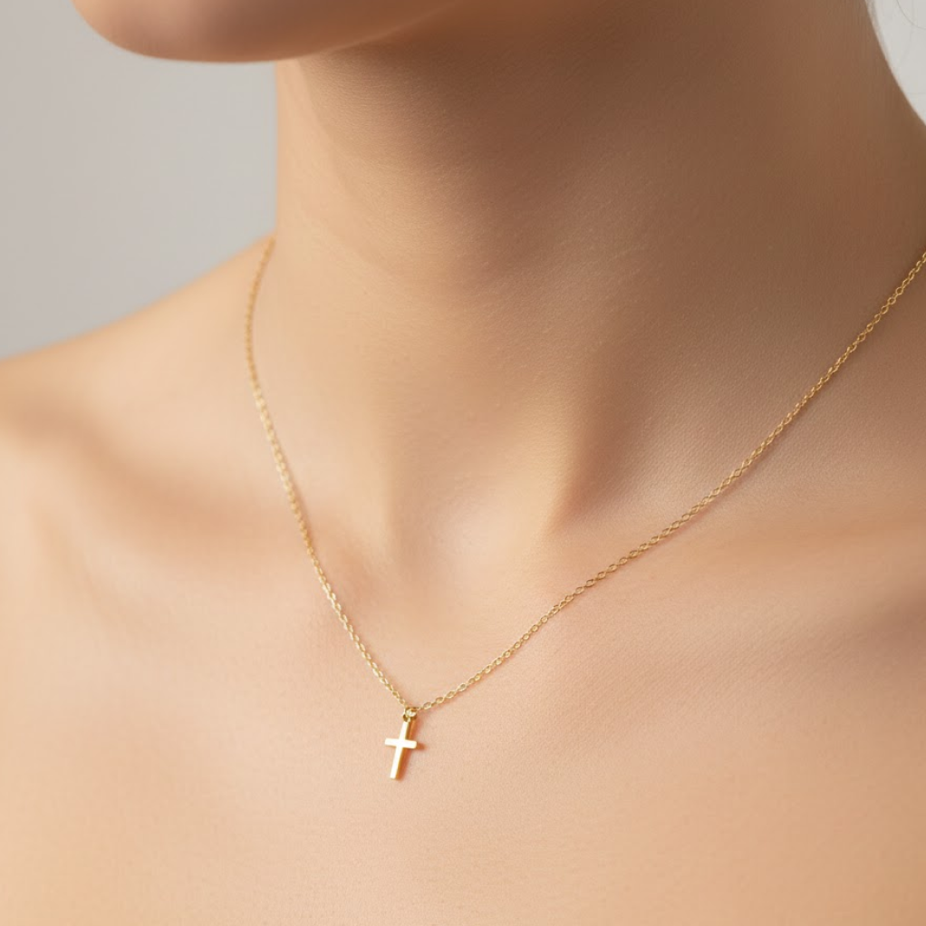 Gold necklace with a cross pendant on a neutral background