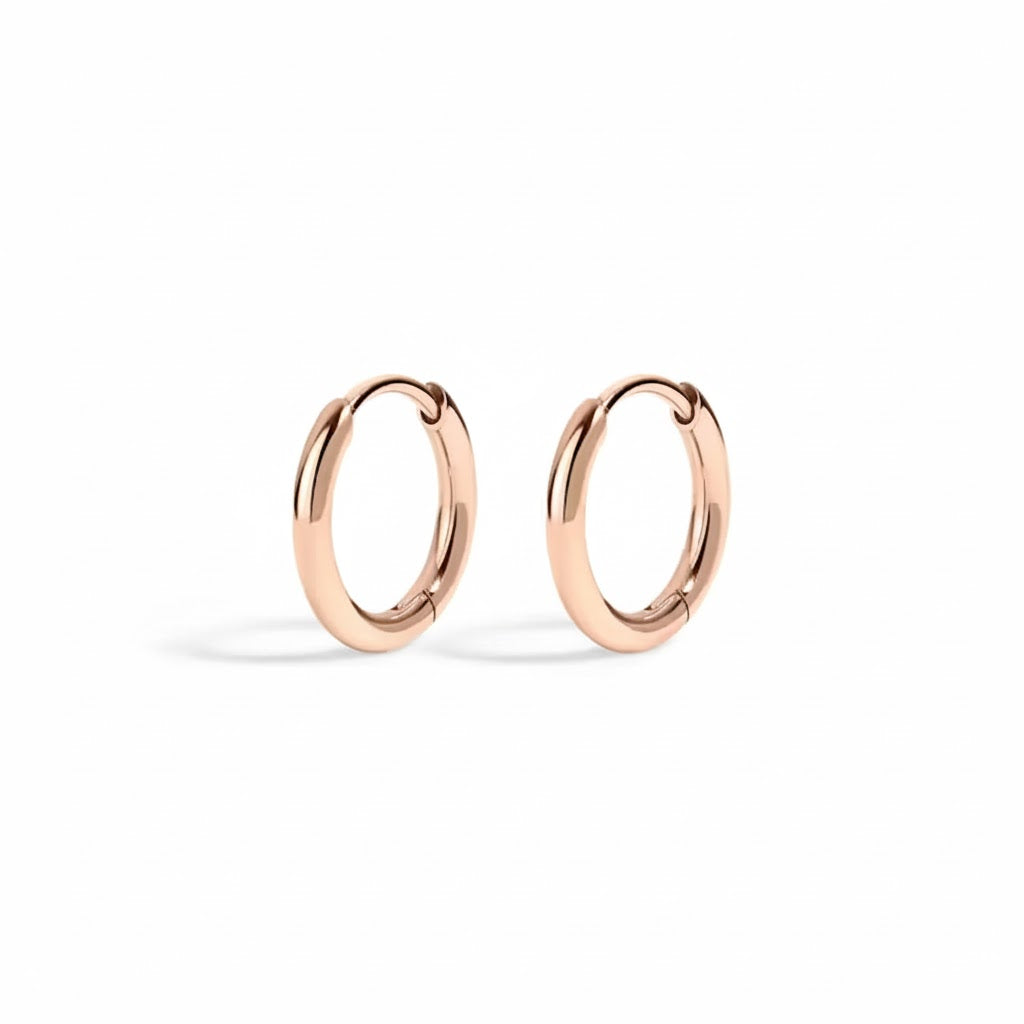 Rose gold hoop earrings on a white background