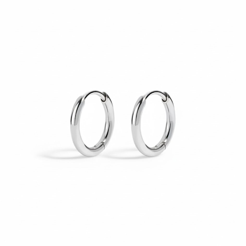 Pair of silver hoop earrings on a white background